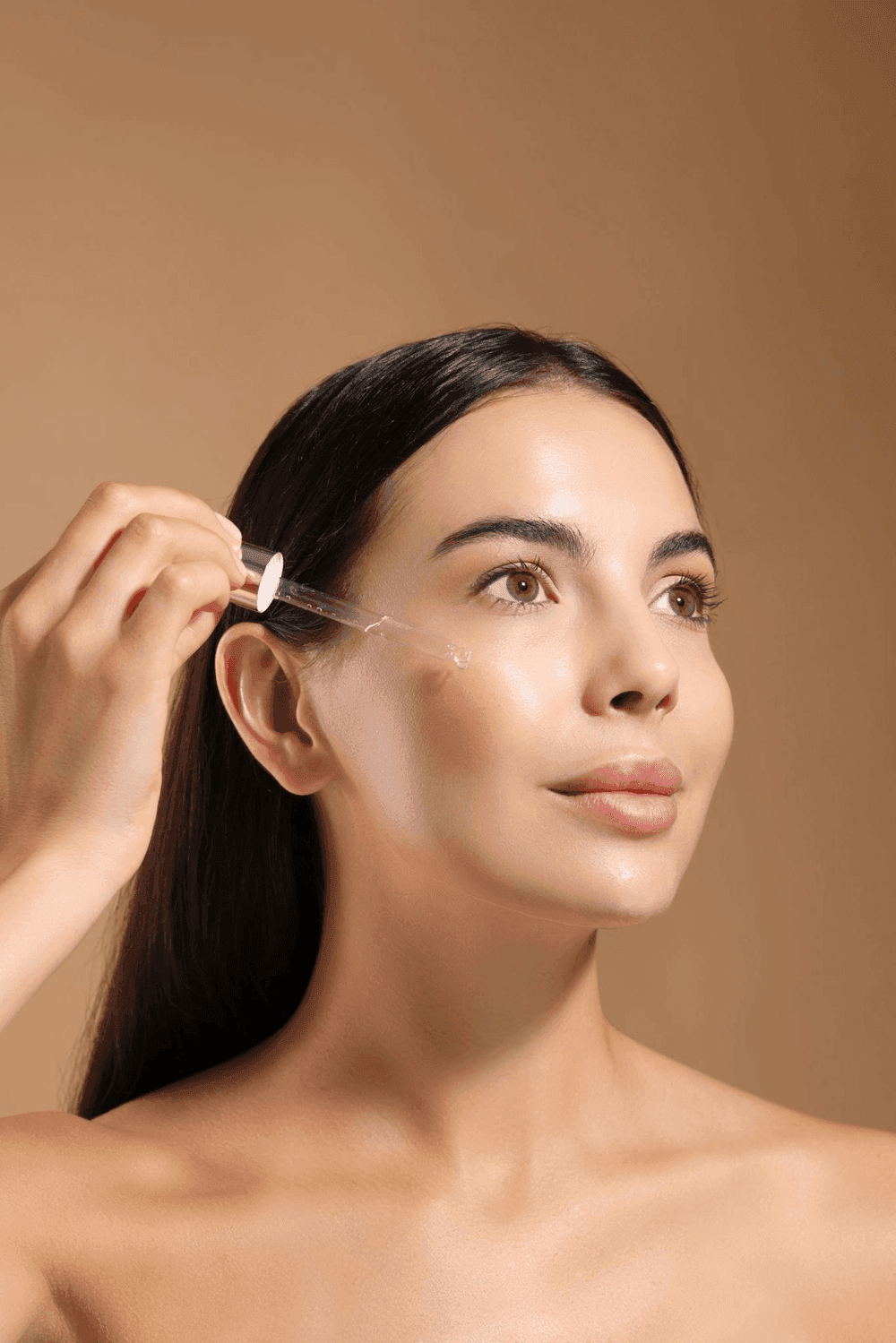 Woman applying Vitamin C Glow Serum